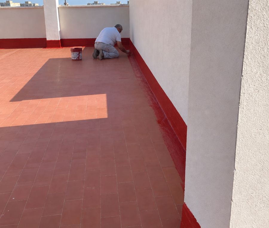 Operario de Pinturas Pizarro sellando el encuentro del peto durante la impermeabilización de una terraza